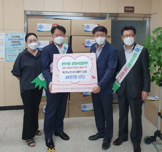 한수원 성장사업본부 봉사단에서 동천동을 방문해 온수매트를 전달한 후 함께 사진촬영을 하는 모습