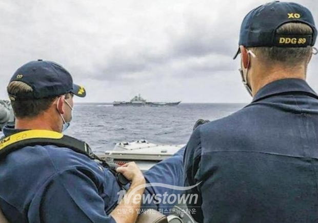 동중국해에서 미국 머스틴함 지휘관이 선박 난간에 다리를 올린 채 중국 랴오닝함을 바라보고 있다. 중국 군사력을 보는 미군의 인식을 잘 보여주는 사진이다./홍콩 명보